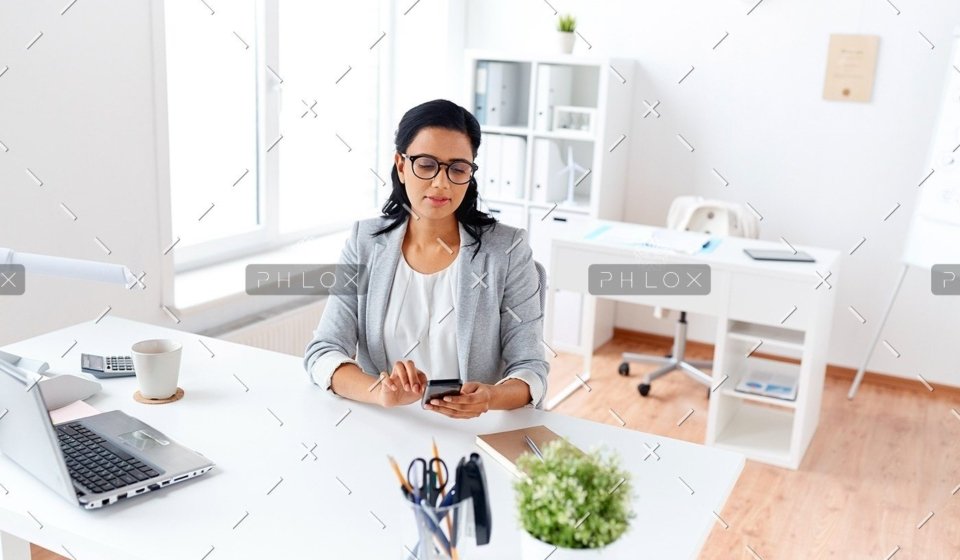demo-attachment-71-businesswoman-messaging-on-smartphone-at-office-P5AQU8Y